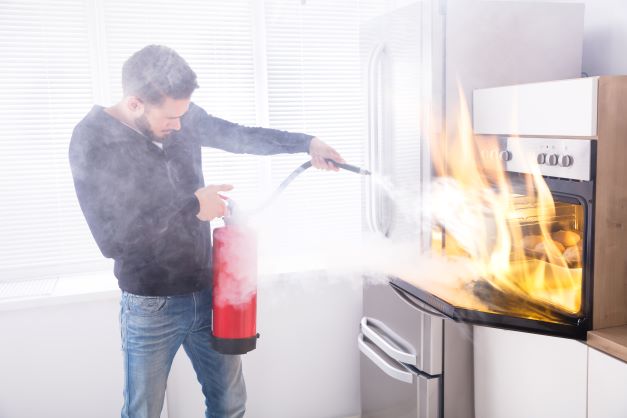 man using fire extinguisher