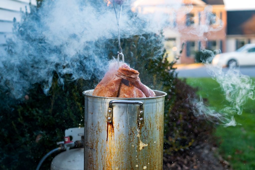 Steaming hot turkey coming out of the fryer