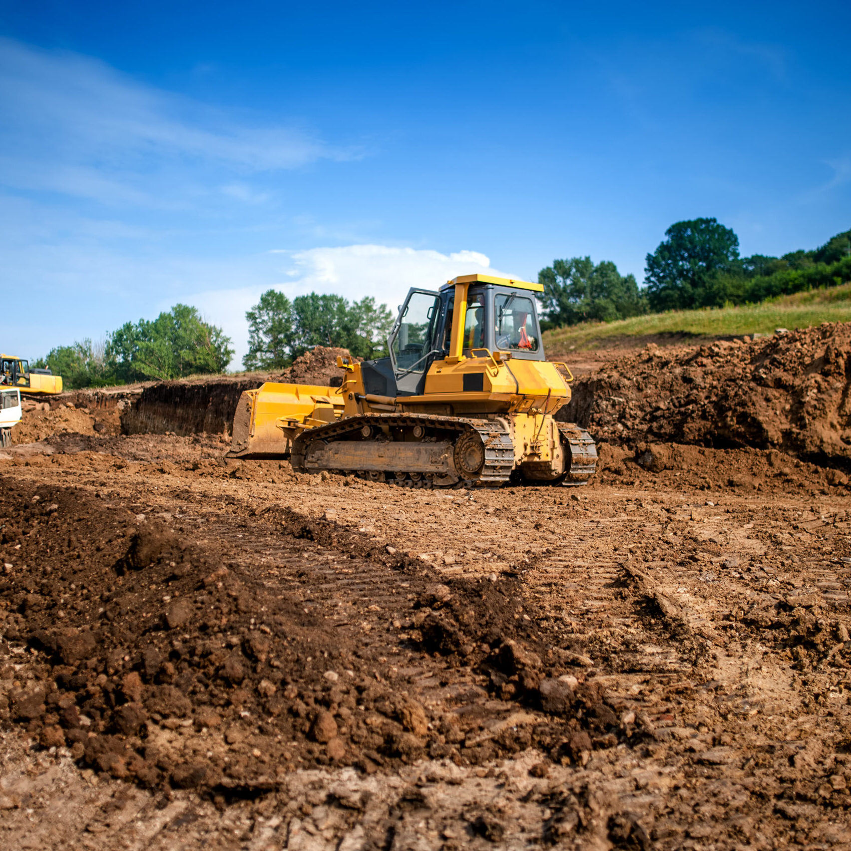 industrial machinery at working construction building site. Excavator, dumper truck and bulldozer working on ground